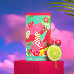 Alani Nu Cherry Twist Energy Stick in a glass of water ready to sip.