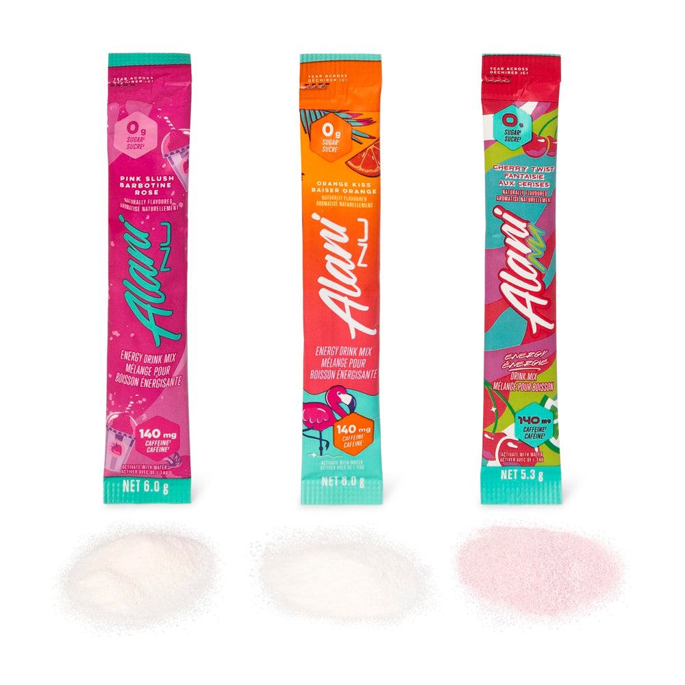 Alani Nu packaging beside glass emphasizes desk-side energy routine.
