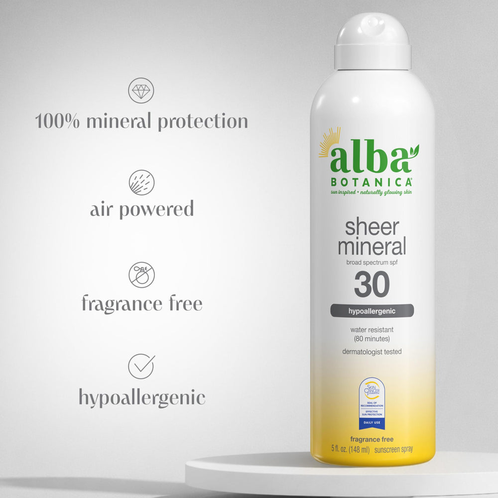Woman applying Alba Botanica sunscreen spray for quick, light coverage.