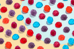 Albanese mixed berry flavors collection showing cherry, strawberry, grape gummies.