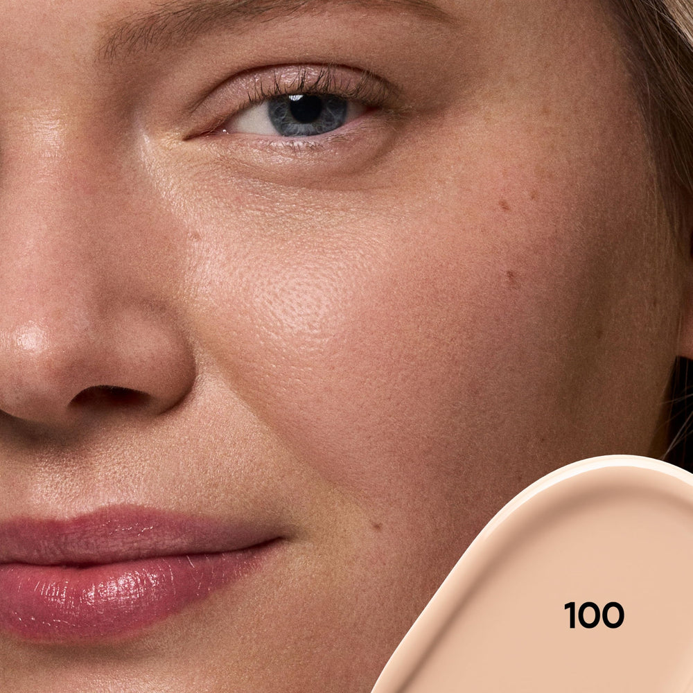 Close-up of concealer being applied on skin for blemish concealment