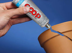 Amazing GOOP clear adhesive spread on wood for a flexible seal.