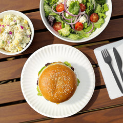 Amazon Basics 9in uncoated white paper plates ideal for backyard barbecues and gatherings.
