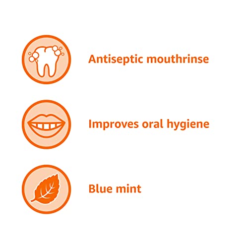 Mouthwash splash beside toothbrushes signaling a refreshing daily care routine