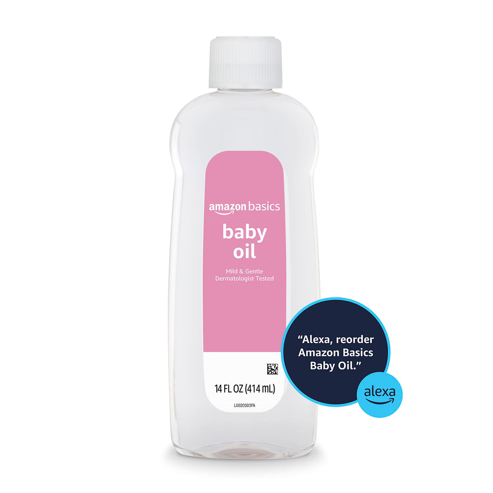 Amazon Basics Baby Oil in hands with child demonstrates gentle skincare routine.