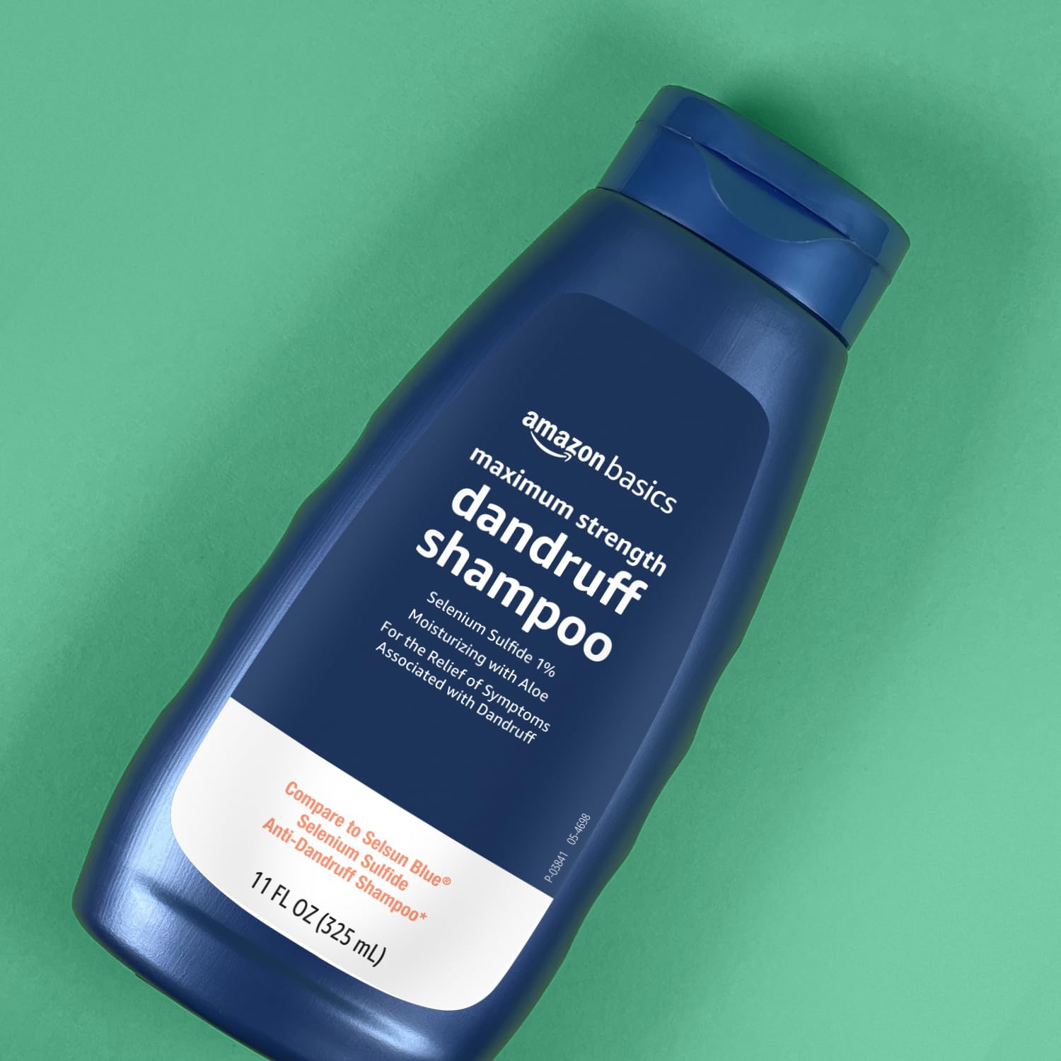 Amazon Basics Moisturizing Dandruff Shampoo packaging on store shelf.