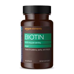 Amazon Elements Biotin 5000 mcg bottle close-up highlighting hair and nails support.