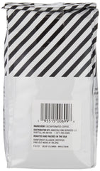 Amazon Fresh Decaf Colombia brew cup with steam highlights citrus aroma and smooth finish.