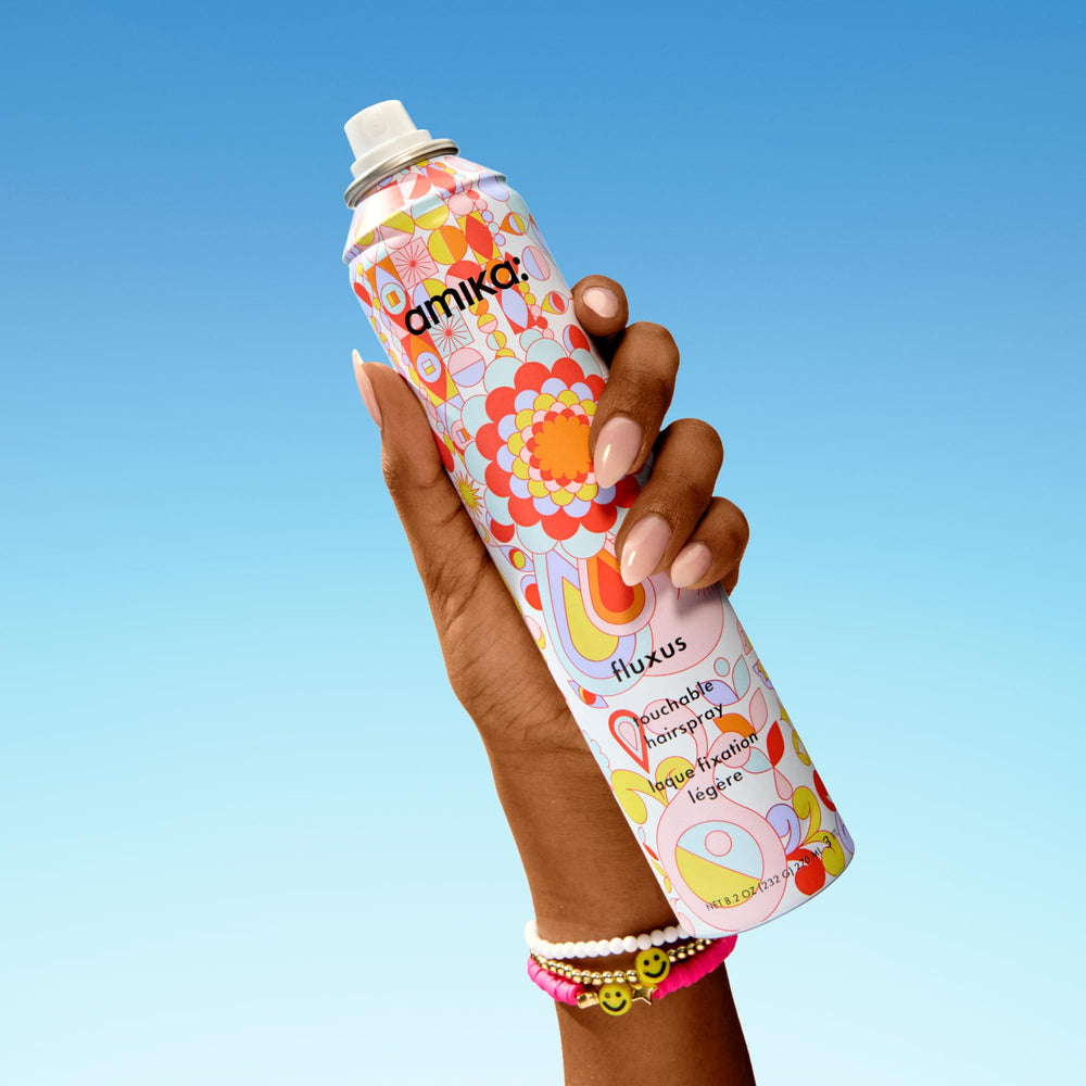 Amika Fluxus Touchable Hairspray mist demonstrates ultra-dry spray and effortless control.