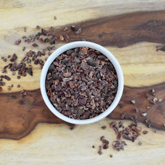 Close-up texture view of Anthony's Organic Cacao Nibs for baking and toppings.