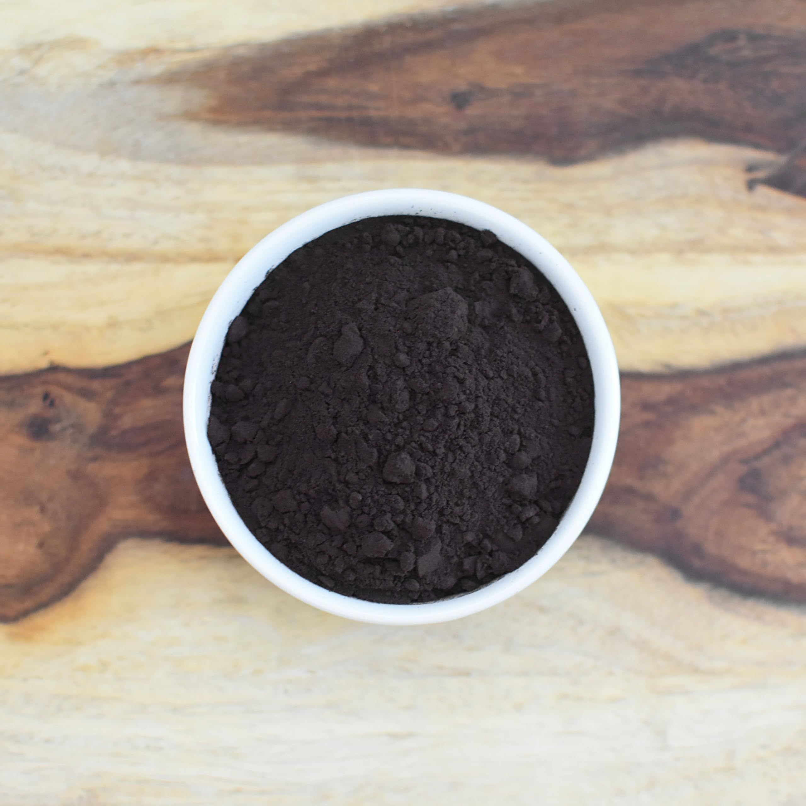 Anthony's black cocoa powder close-up reveals dense dark color for rich desserts.