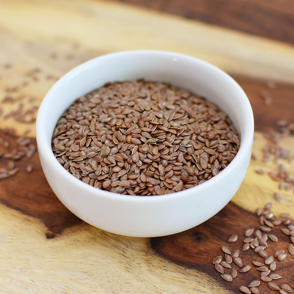 Pouring Anthony's Flaxseed into a jar for sprouting and storage.