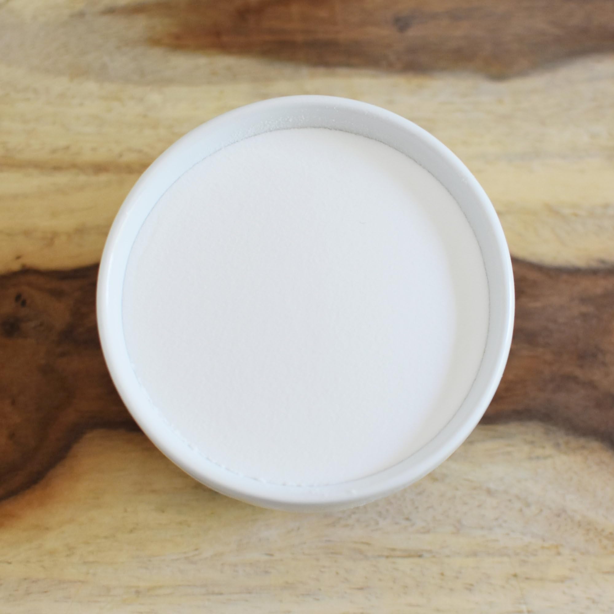Anthony's Organic Inulin Powder poured into a glass for beverages.