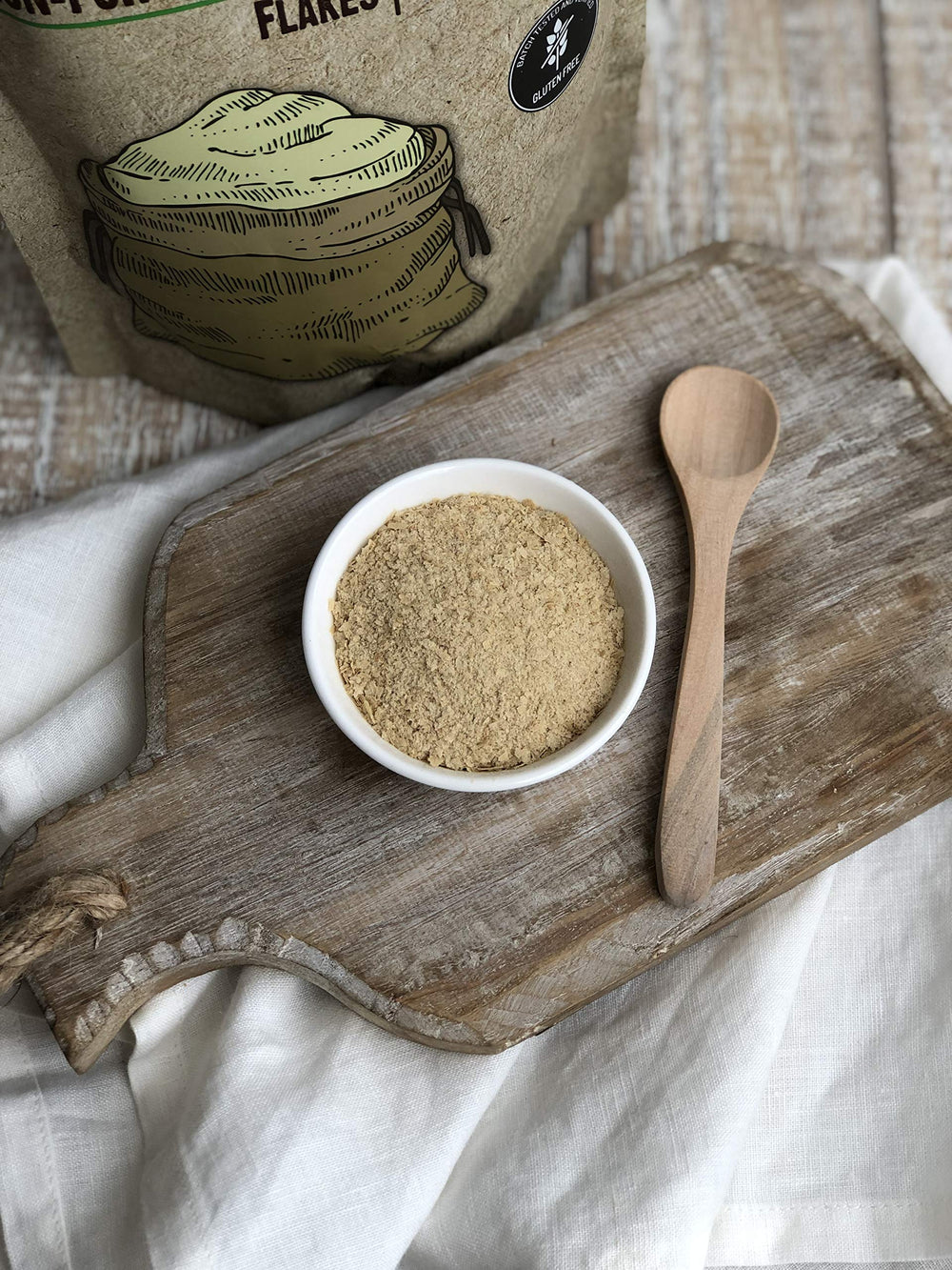 Packaging close-up of Anthony's Nutritional Yeast Flakes showing gluten-free and non-GMO quality.