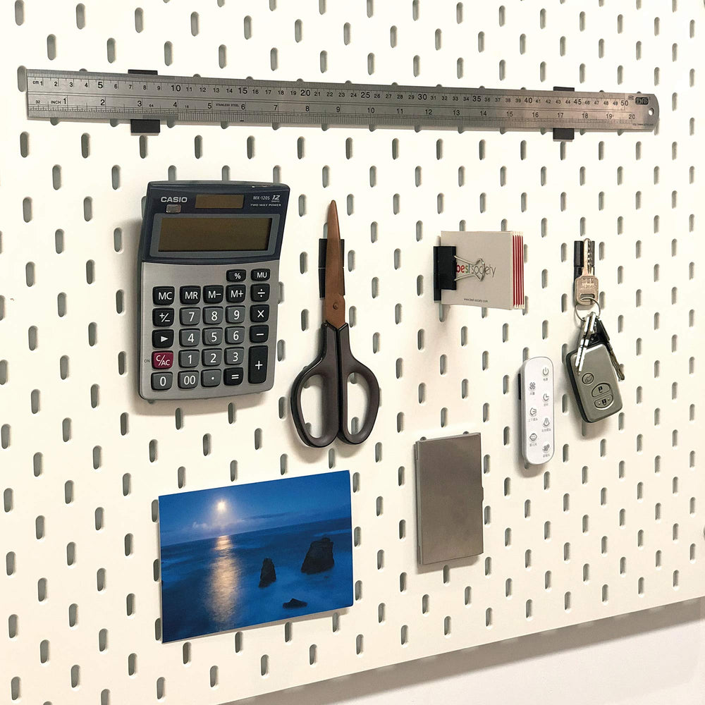 Fridge organization setup showing magnets holding lightweight items.