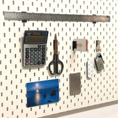 Fridge organization setup showing magnets holding lightweight items.