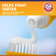 Arm & Hammer peanut butter flavored puppy toothpaste near a dog's mouth for easy brushing.