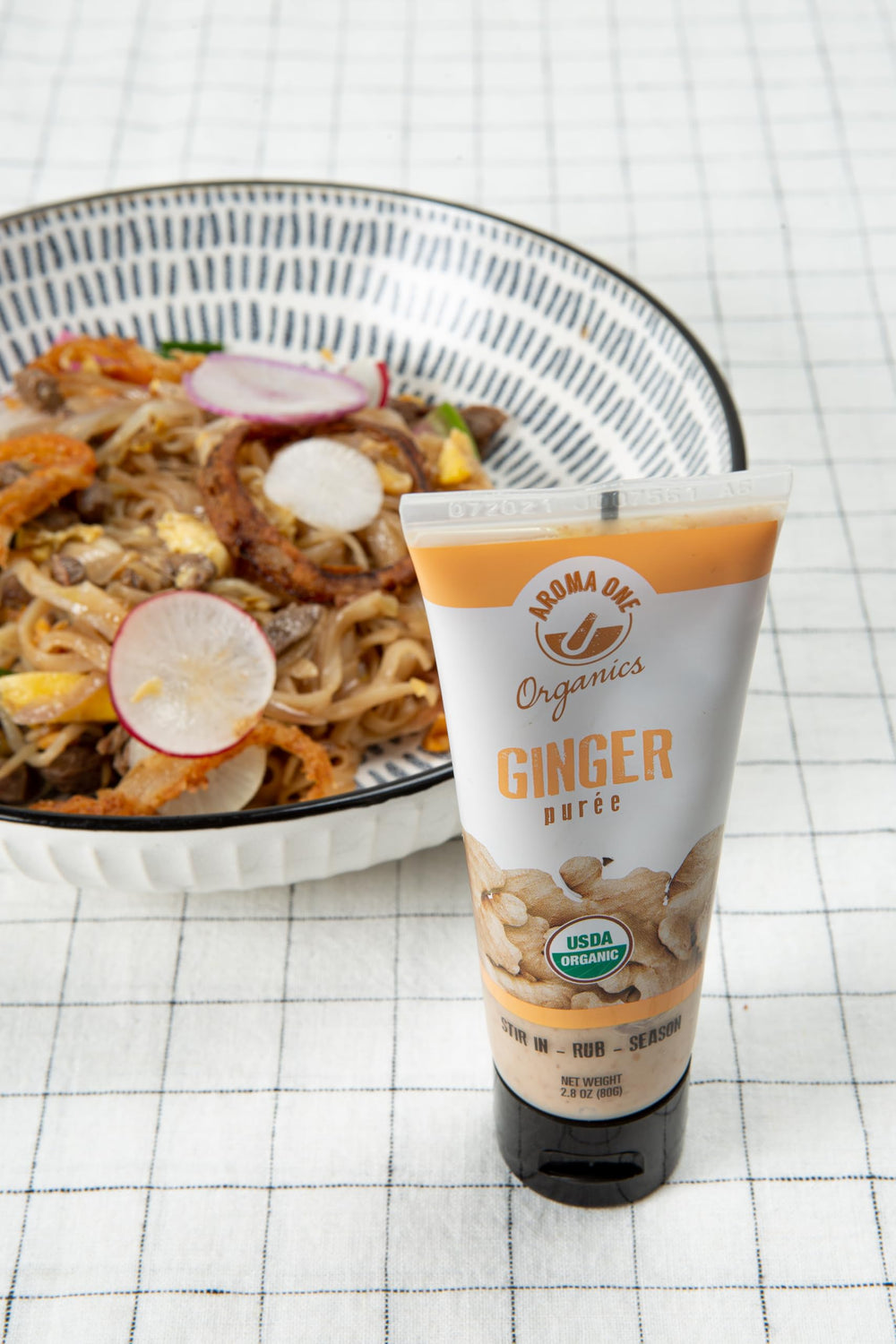 Squeeze-action shot of Aroma One ginger paste for quick weeknight meals.