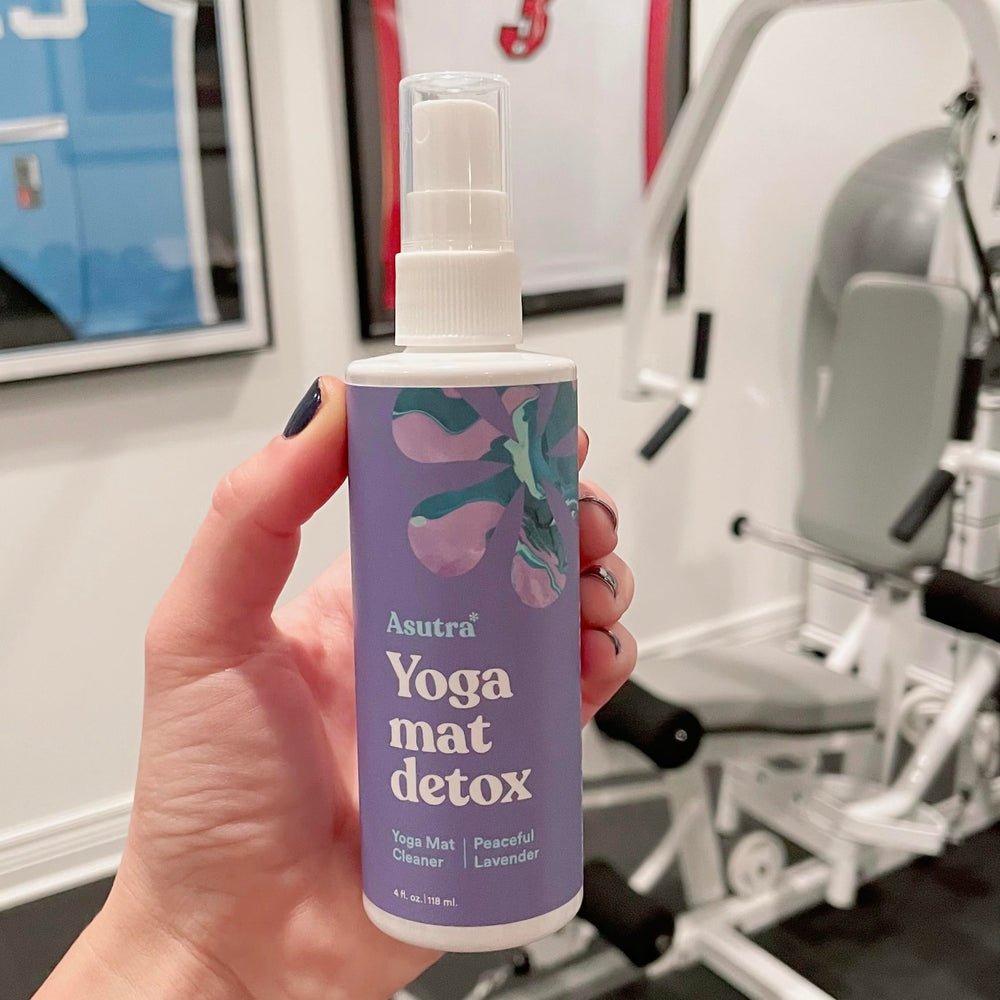 ASUTRA Yoga Mat Cleaner packaging beside included towel for convenient care