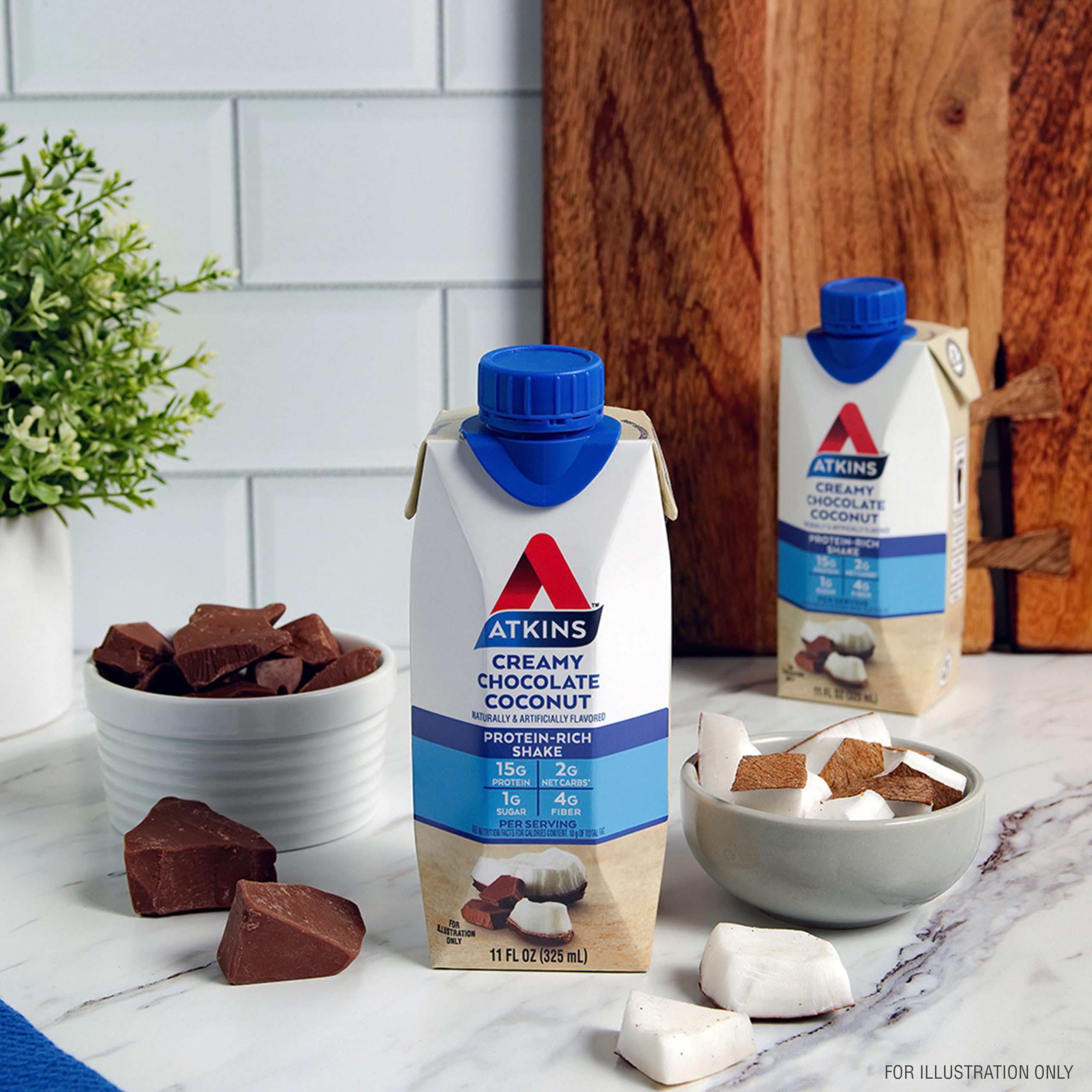 Atkins Creamy Chocolate Coconut Shake label close-up underlines fiber and low net carb content.