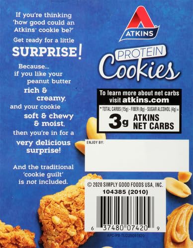 Atkins cookie in hand illustrating a portable keto snack for busy days.