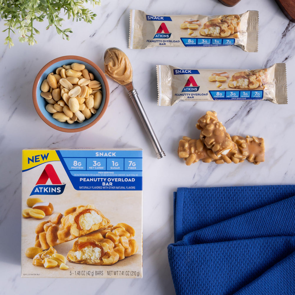 Atkins Peanutty Overload bar nutrition facts label visible.