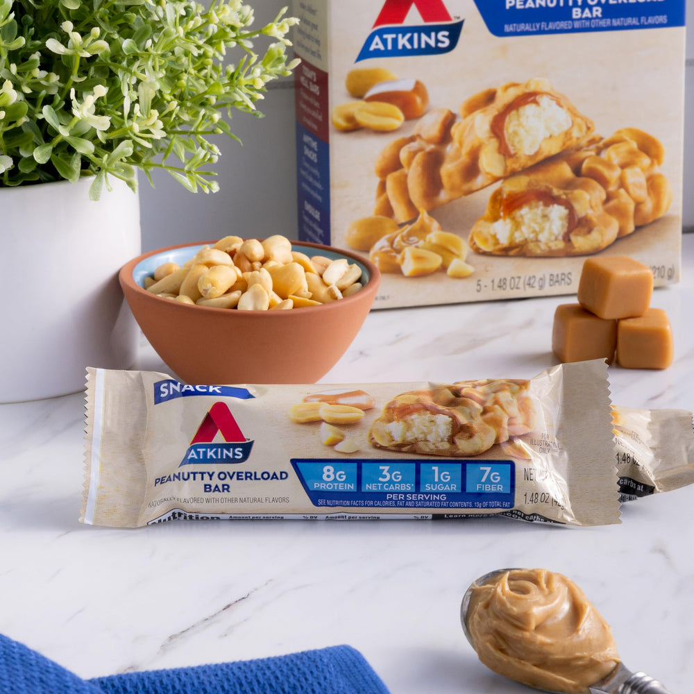 Atkins Peanutty Overload bar texture highlighting nuts and coating.