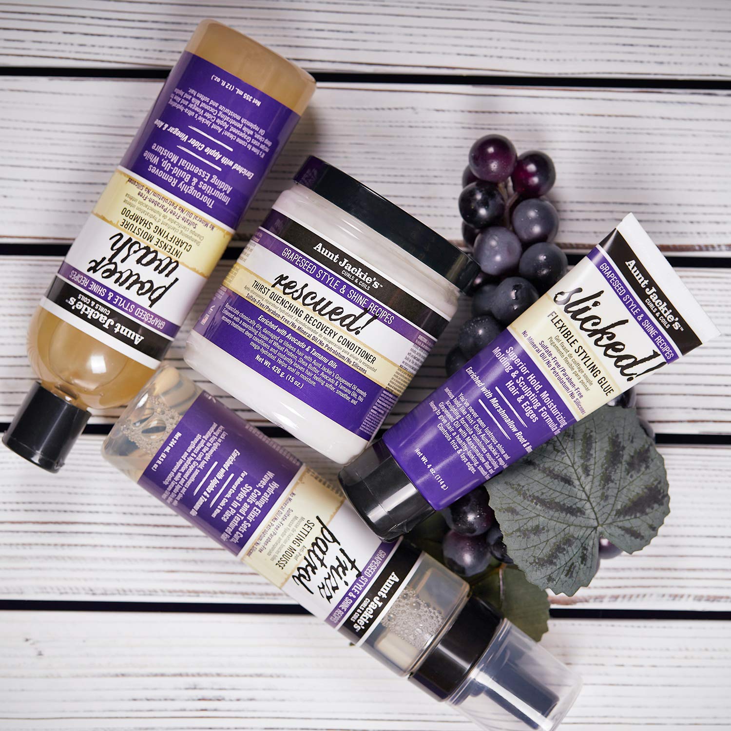 Aunt Jackie's Frizz Patrol bottle beside ingredient imagery showing oils blend.