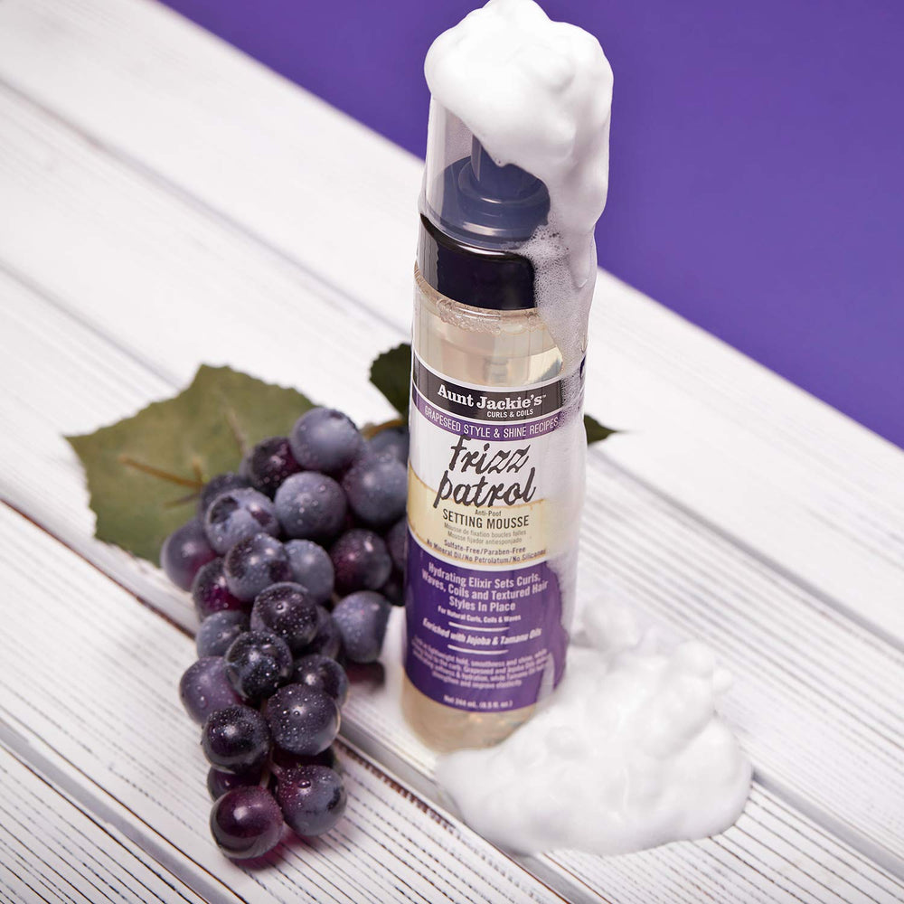Aunt Jackie's Frizz Patrol mousse on curly hair delivering smooth definition.