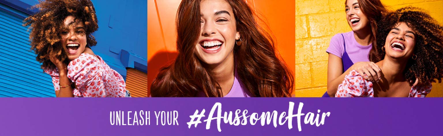 Aussie Miracle Moist conditioner on sink counter implies slip-through softness.