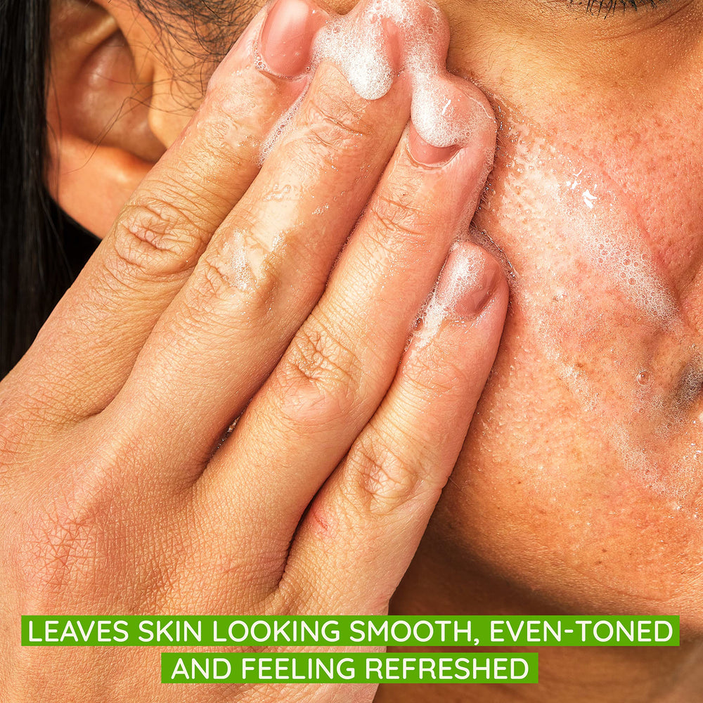 Aveeno Positively Radiant scrub beads close-up highlights gentle exfoliation for smoother skin