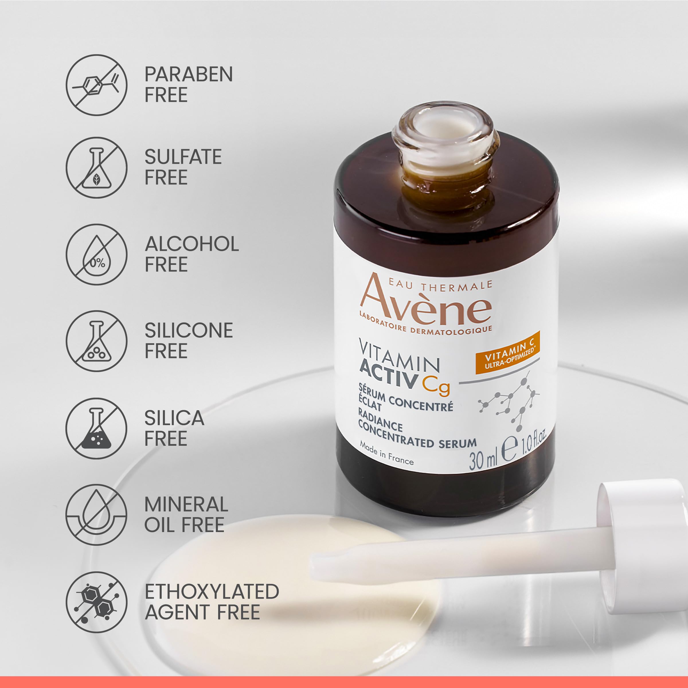 Hand holding Avène Vitamin Activ Cg Serum bottle for easy absorption.