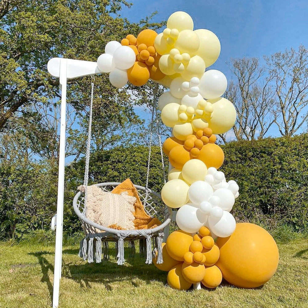 Awenztech gender reveal backdrop using pastel yellow balloons.