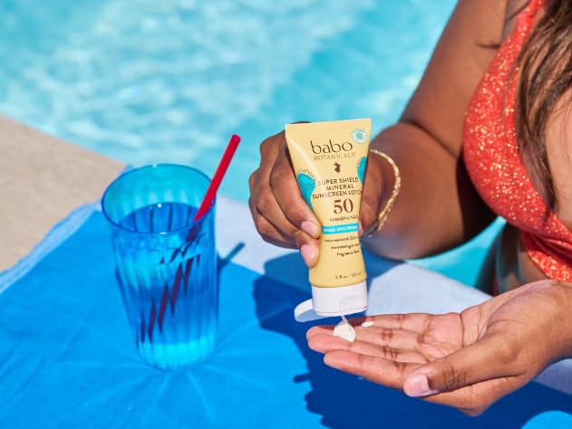 Babo Botanicals sunscreen bottle on kid-friendly packaging showcases family use.