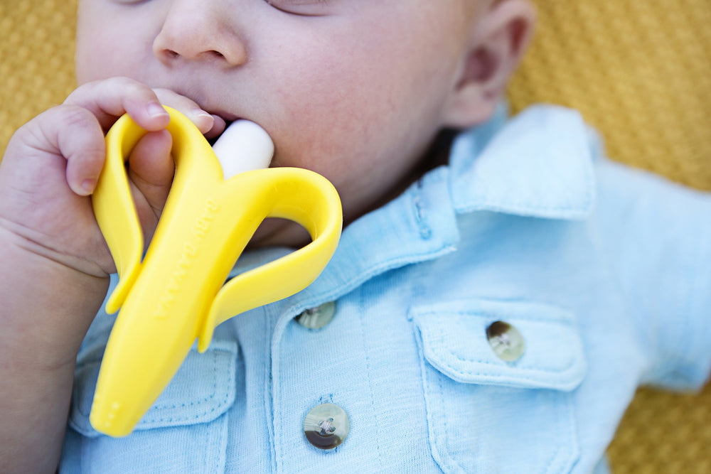 Baby Banana mouth massage action highlights teething comfort for little ones.