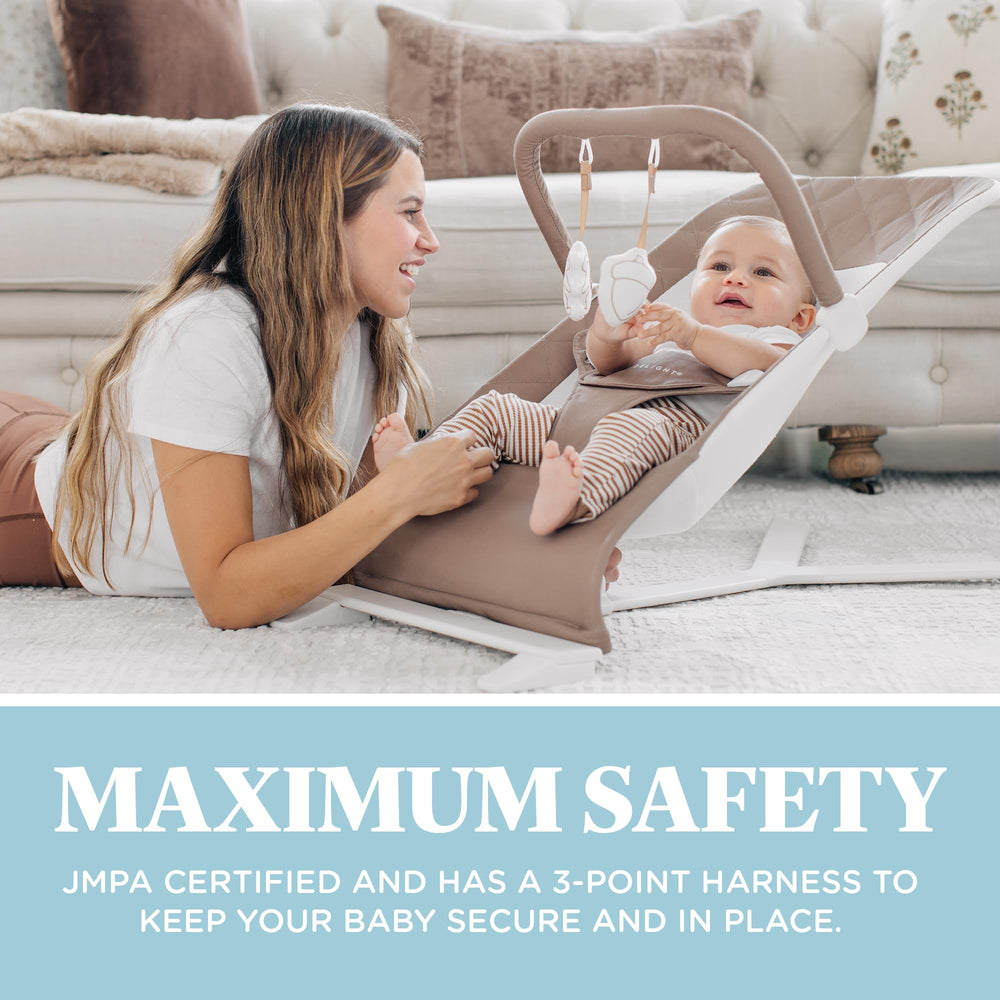 Removable toy bar with plush toys enhances playtime on the Baby Delight Alpine Deluxe.