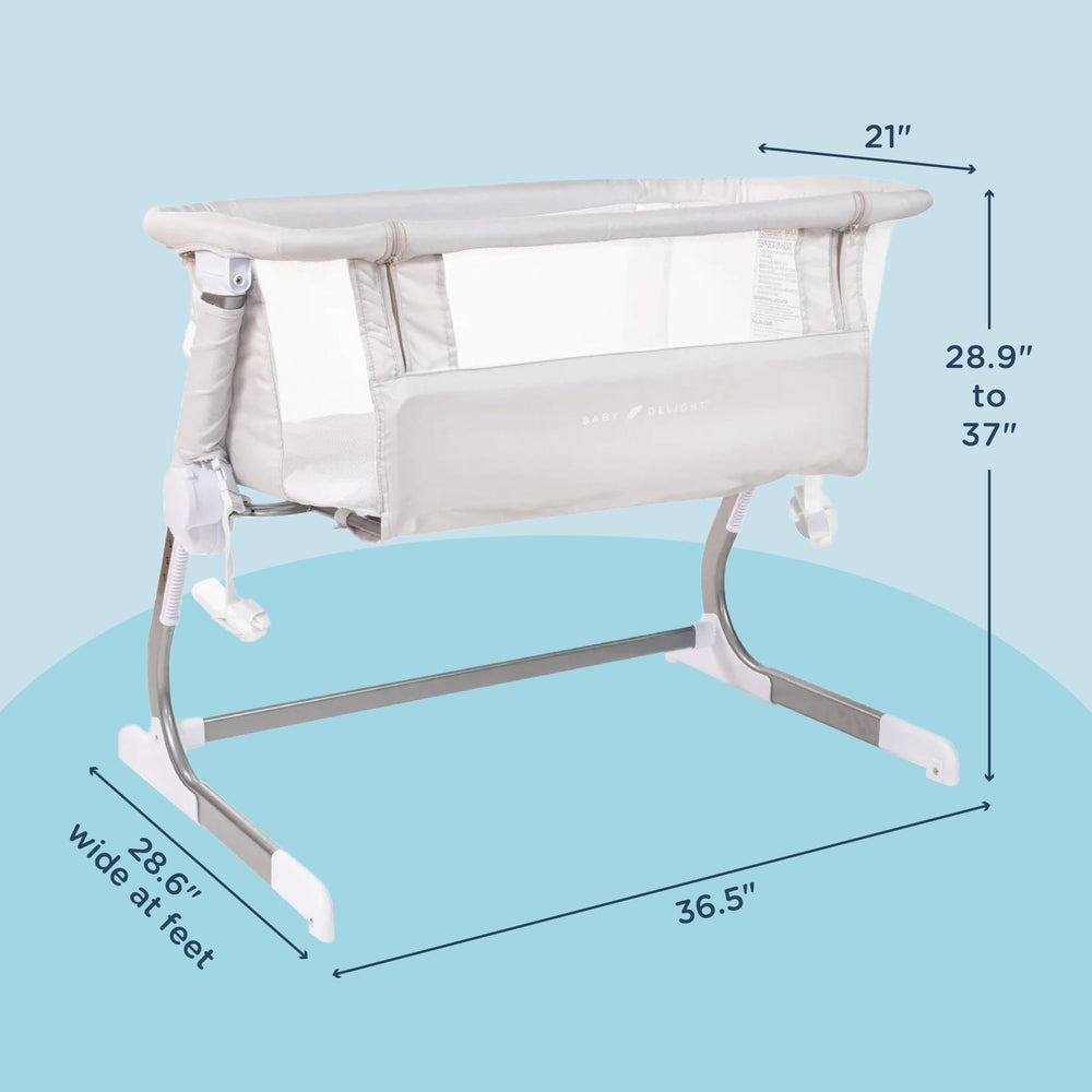 Baby Delight Beside Me Dreamer Bassinet anchors securely to bed for snug bedside setup.