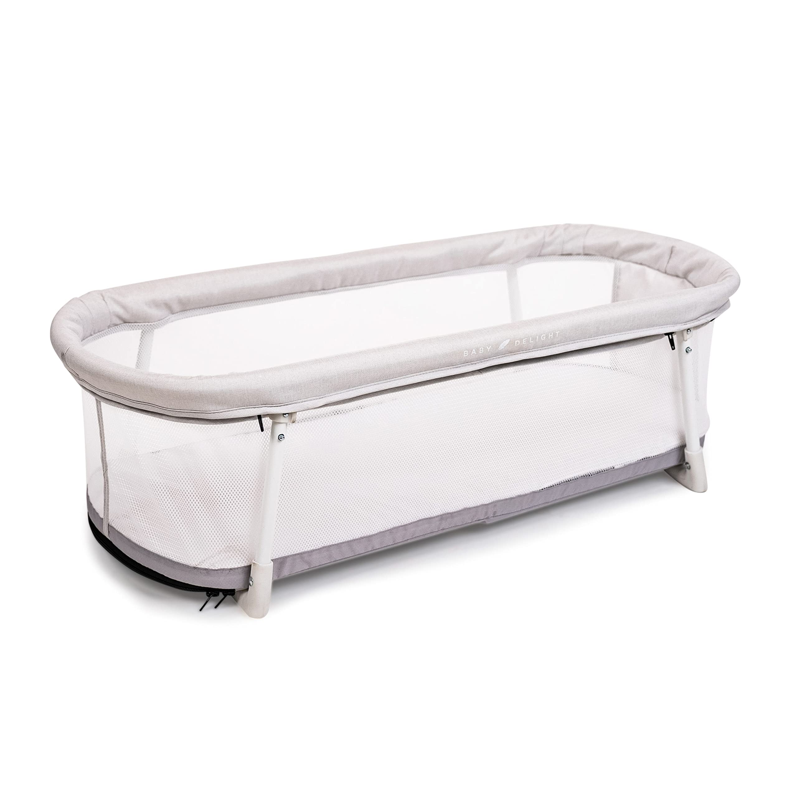 Baby Delight Snuggle Nest Bassinet in Driftwood Grey with fold-out legs for portability.