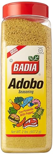 Badia Adobo seasoning being poured over ingredients for savory, smoky depth.