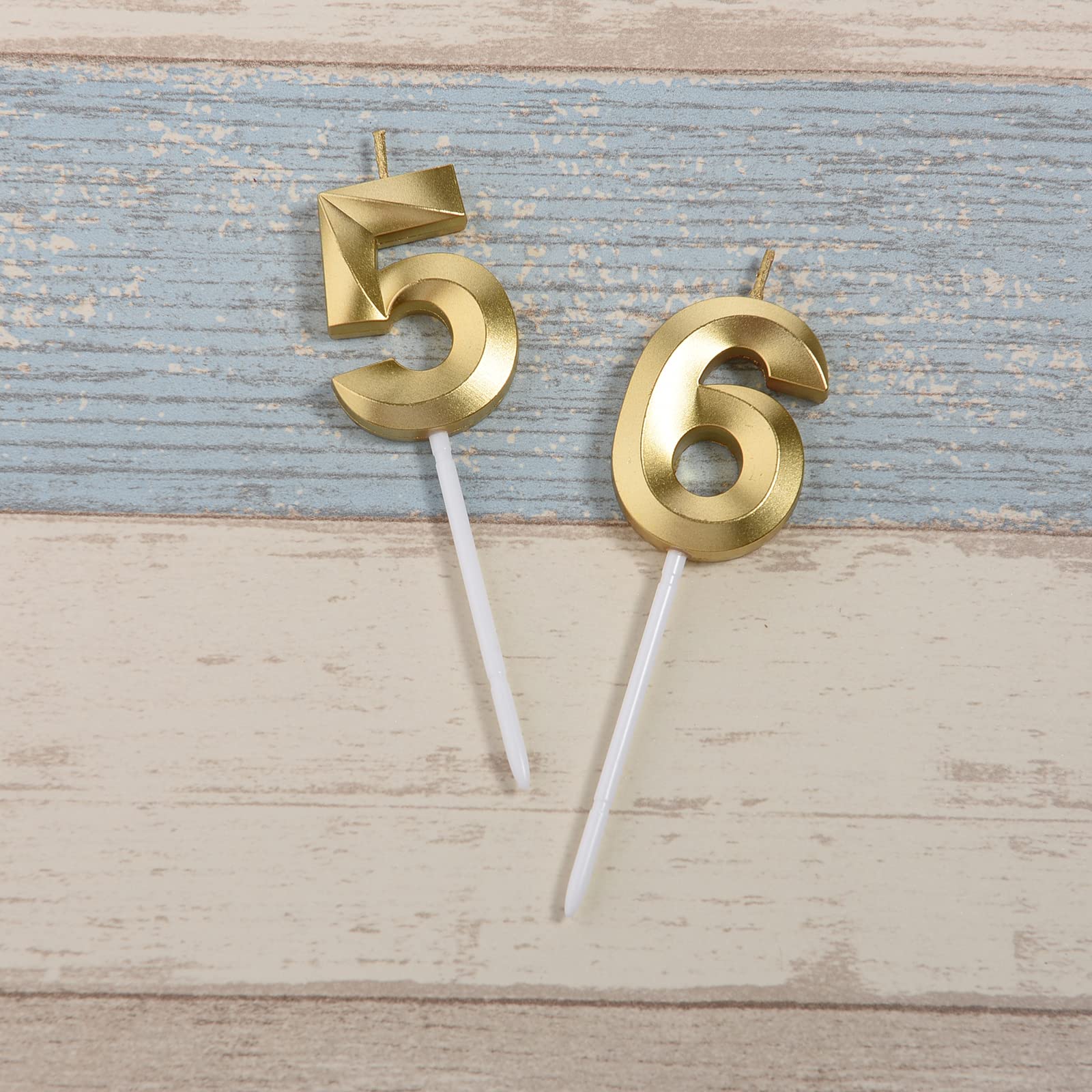 Bailym gold number 56 cake topper in close-up on celebration cake