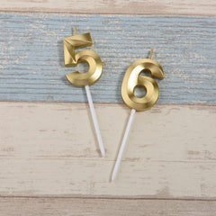 Bailym gold number 56 cake topper in close-up on celebration cake