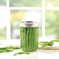 Ball glass mason jar designed for easy preserving in kitchen.