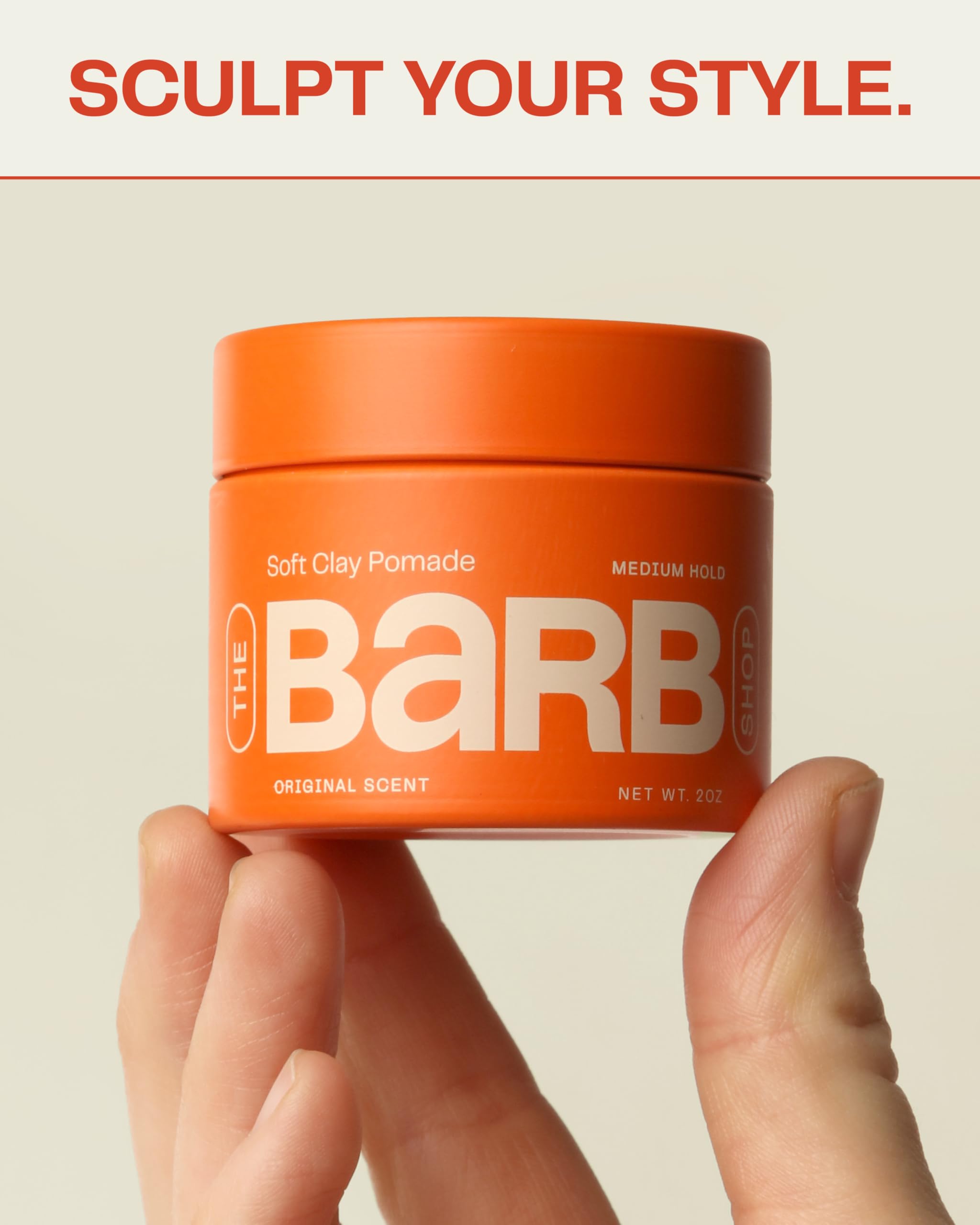 Creamy texture of Barb Soft Clay Pomade dispensed into hands for easy styling.