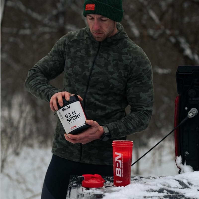 Athlete using shake bottle for on‑the‑go fueling.
