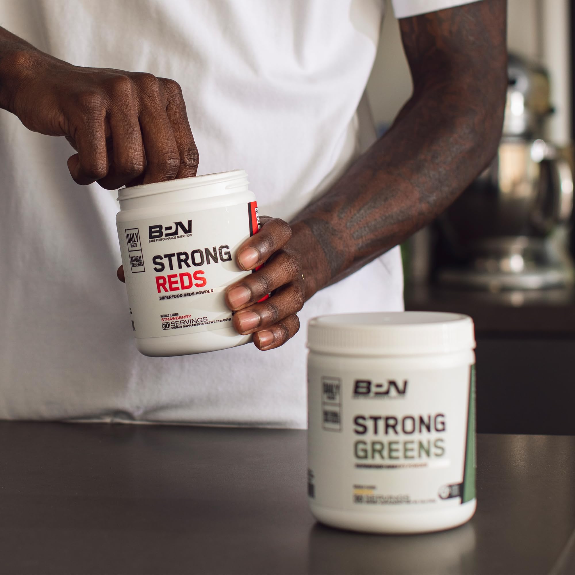 BARE PERFORMANCE NUTRITION Strong Greens morning routine setup with glass of water.