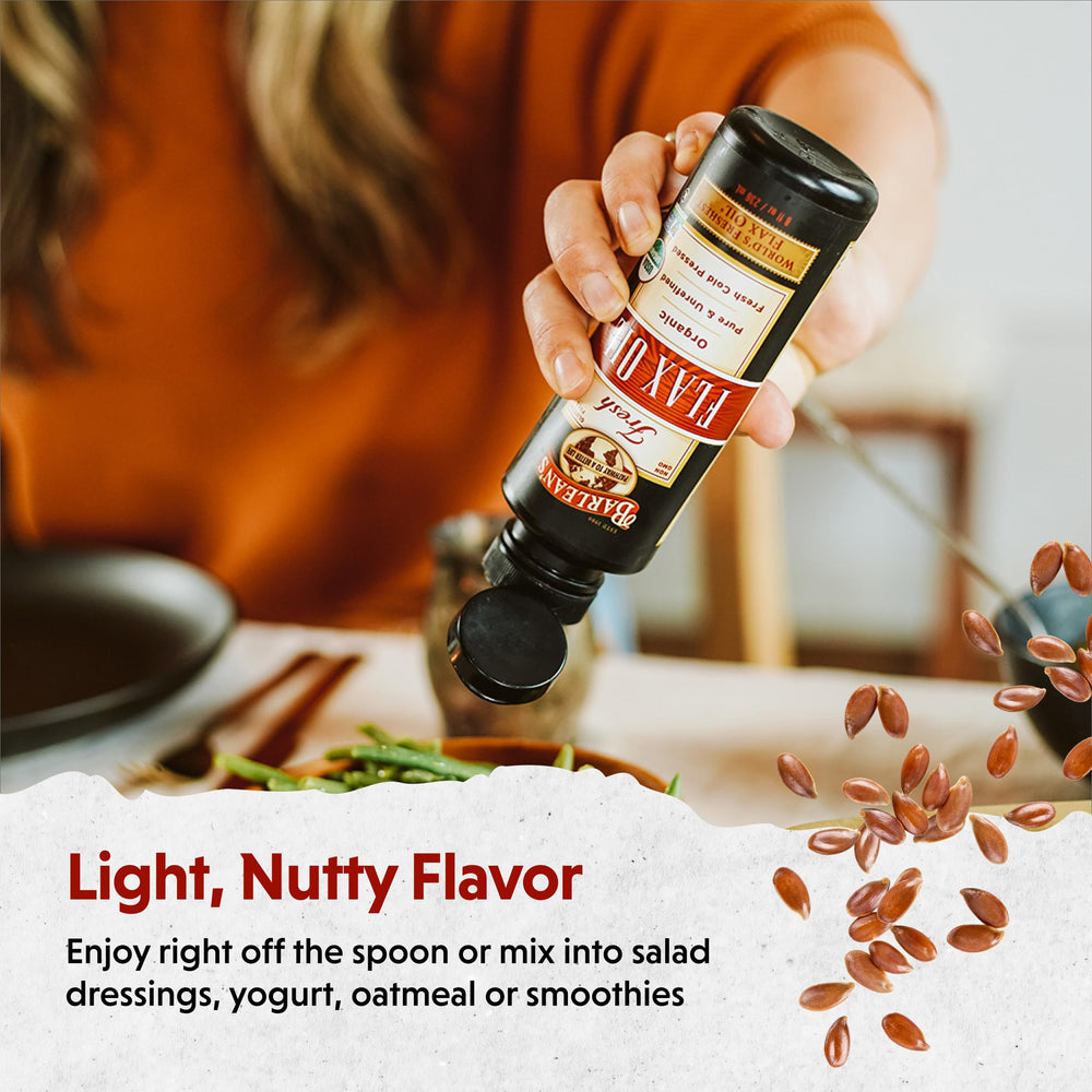 Pouring Barlean's flaxseed oil from dropper into a spoon for dosing.