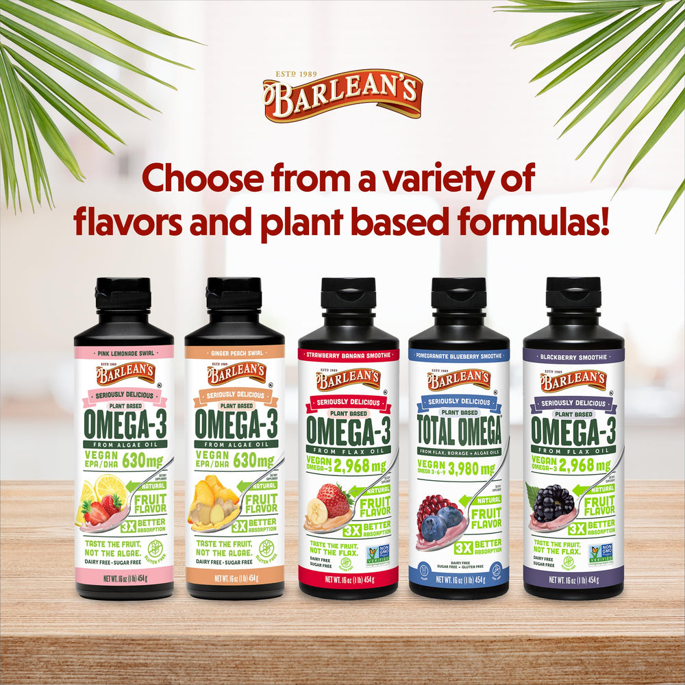 Barlean's vegan flaxseed oil bottle with label beside fruits for a smoothie