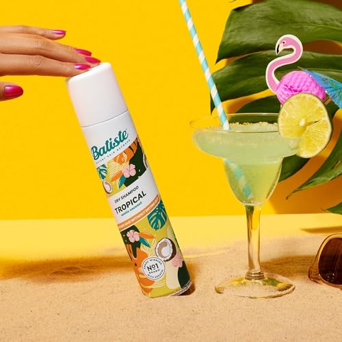 Batiste Tropical dry shampoo beside gym bag for post-workout refresh