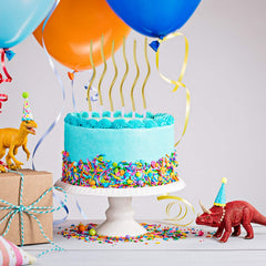 BBTO metallic gold twist candles with plastic holders protect cake surfaces.