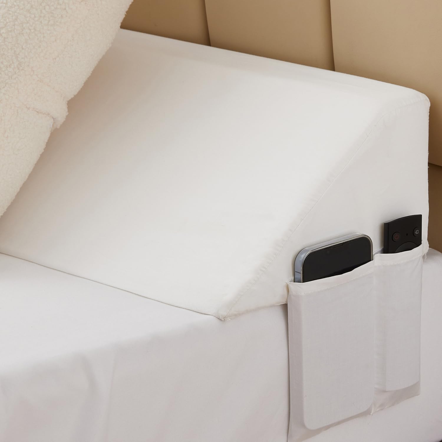 Bedluxe bed gap filler with side pockets keeps remotes within reach.